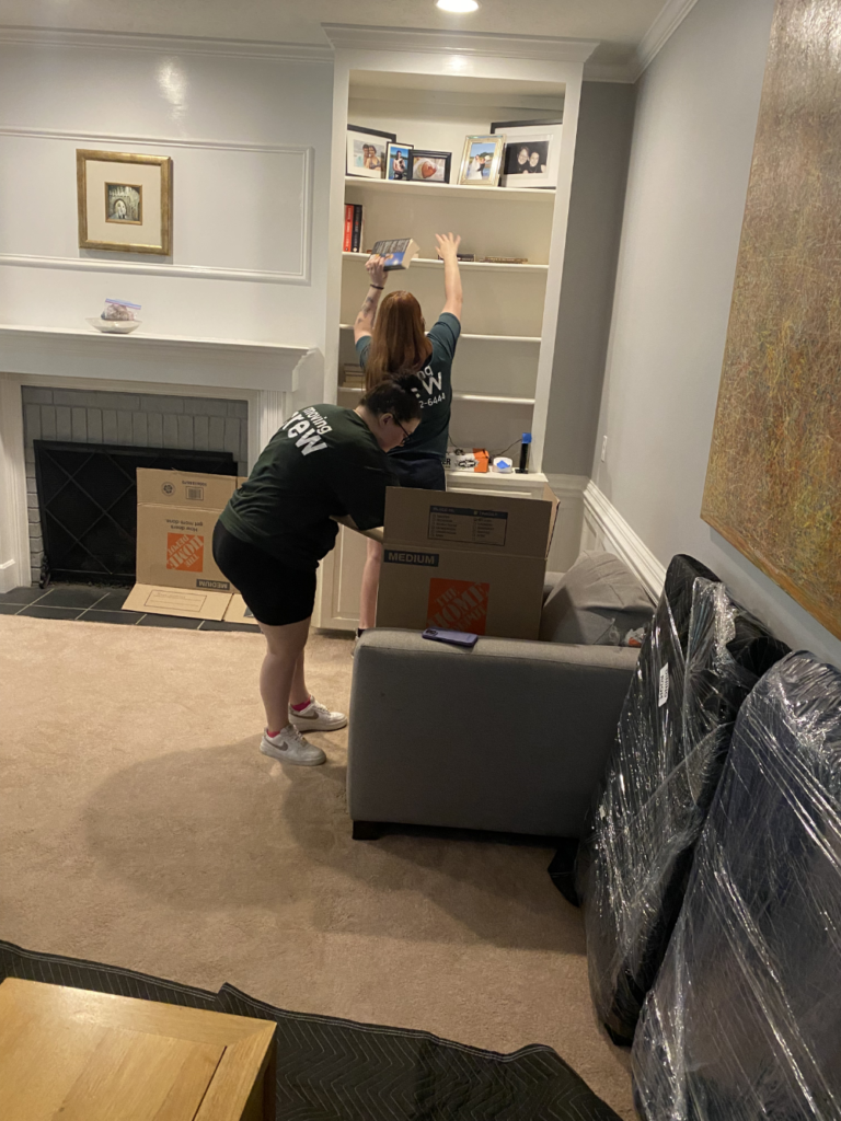 the ladies packing up a living room